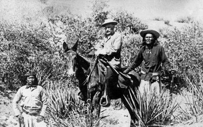 General George Crook on a Mule, with Two Apache in Arizona, 1882 by American Photographer